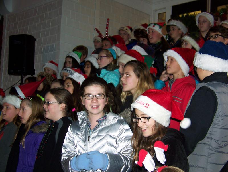 The Rochester Memorial School chorus prepares to sing "A Marshmallow World" at Monday's tree lighting ceremony. BY MATTHEW BERNAT